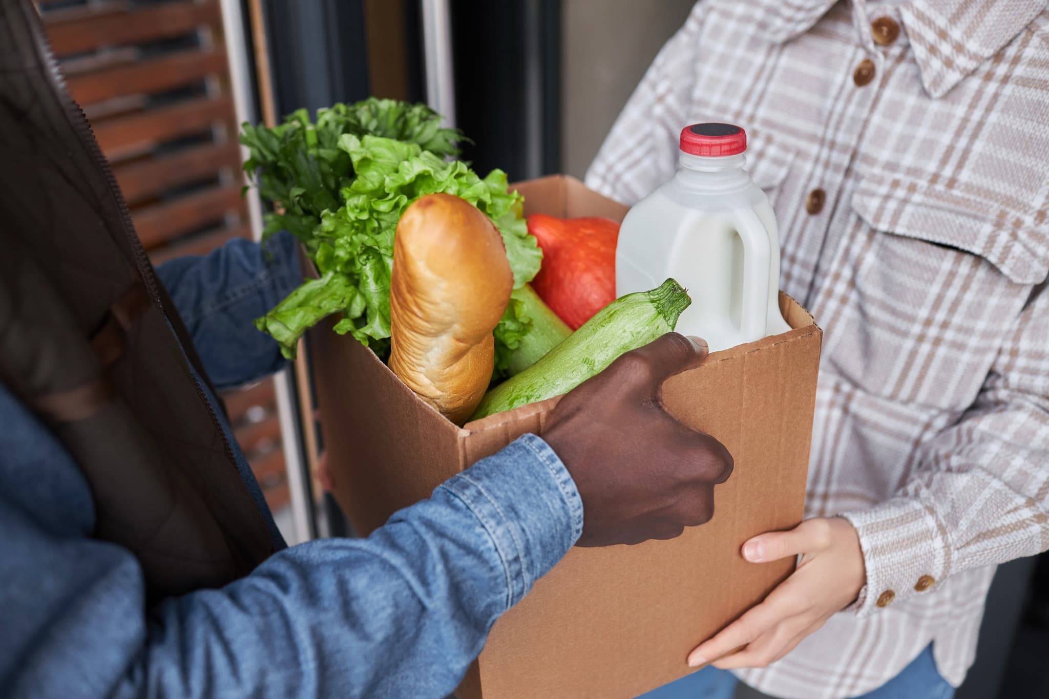 Volunteer delivering groceries and food donations to family in need through M25 Outreach Franklin Indiana