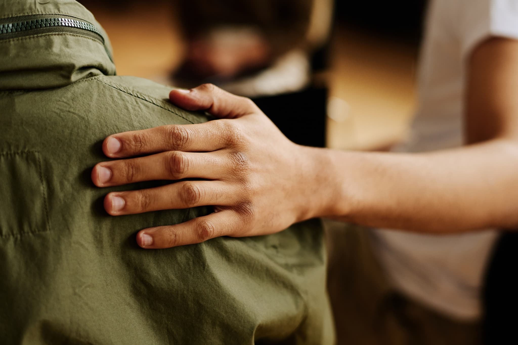 Supportive hands offering comfort at M25 Recovery addiction recovery program Franklin Indiana